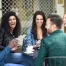 A group of diverse coed friends sharing coffee.